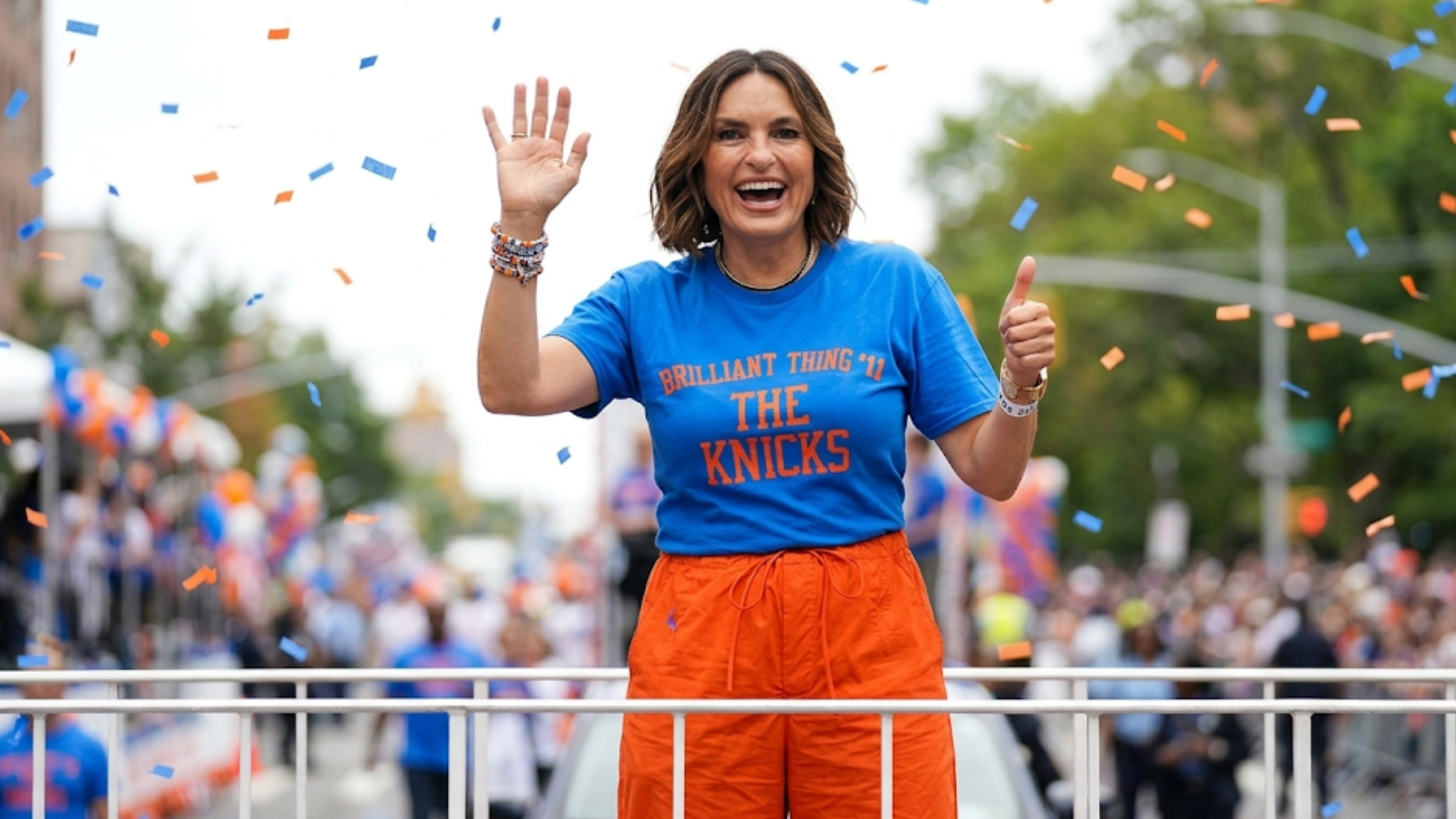 Mariska Hargitay 2026 Knicks championship parade blue T-shirt with orange typography and streetwear game-day styling