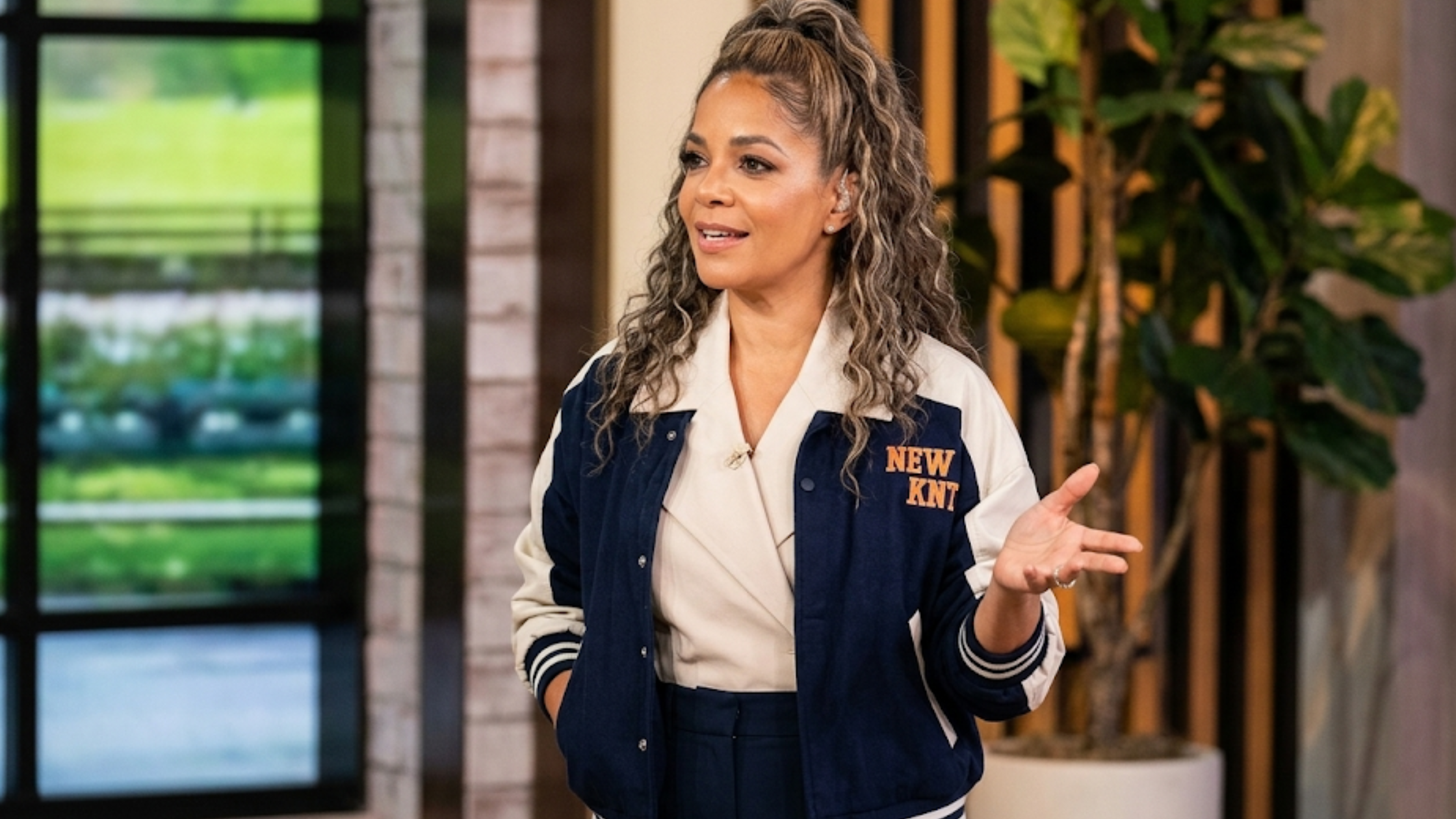 Sunny Hostin New York Knicks varsity jacket from The View 2026 navy cream colorblock with embroidered chest logo and basketball patch back design